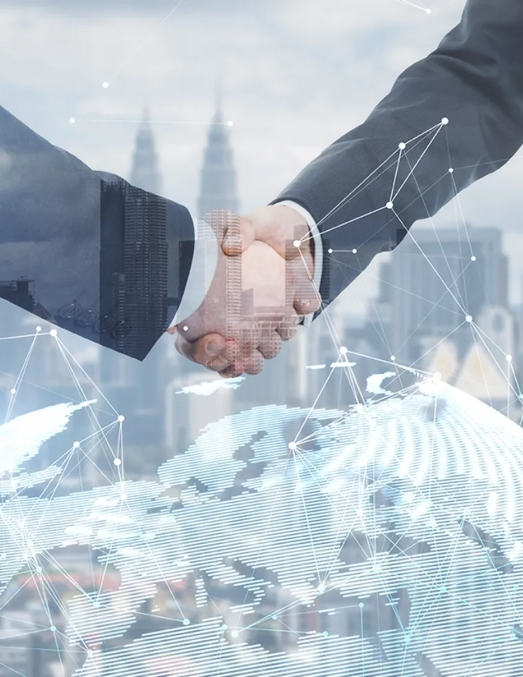 Two business professionals shaking hands with a digital network overlay, symbolizing Trinergy's global business partnerships and technological collaboration.