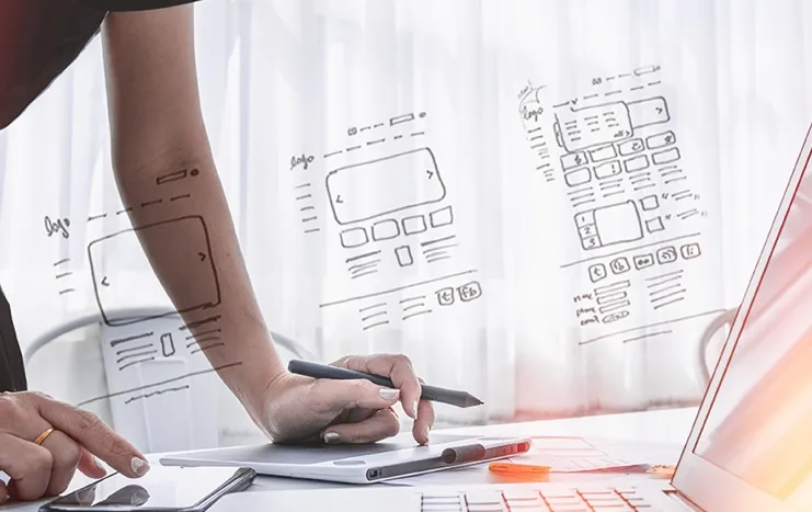 Trinergy's UX/UI design process showcasing wireframe sketches and digital tools for developing intuitive and user-friendly interfaces.