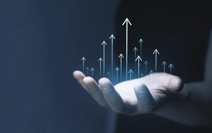 A hand holding upward-pointing digital arrows, symbolizing Trinergy's innovative solutions driving business growth and success.