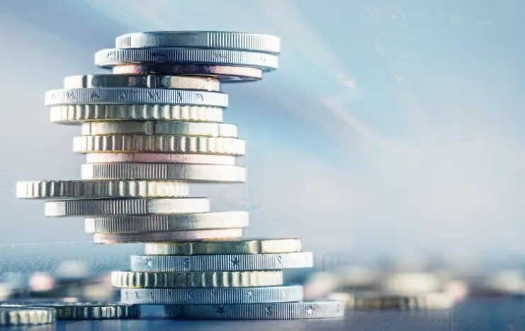 A stack of shining coins representing Trinergy's innovative solutions in financial technology and digital transactions.