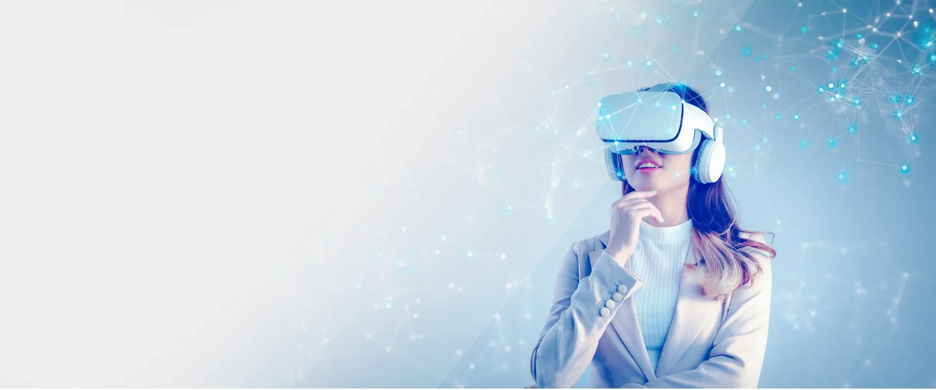 A woman wearing a virtual reality headset, exploring futuristic digital experiences powered by Trinergy's immersive technology solutions.