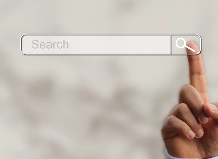 A hand pointing to a search bar, symbolizing Trinergy’s expertise in enhancing online business visibility through SEO strategies.