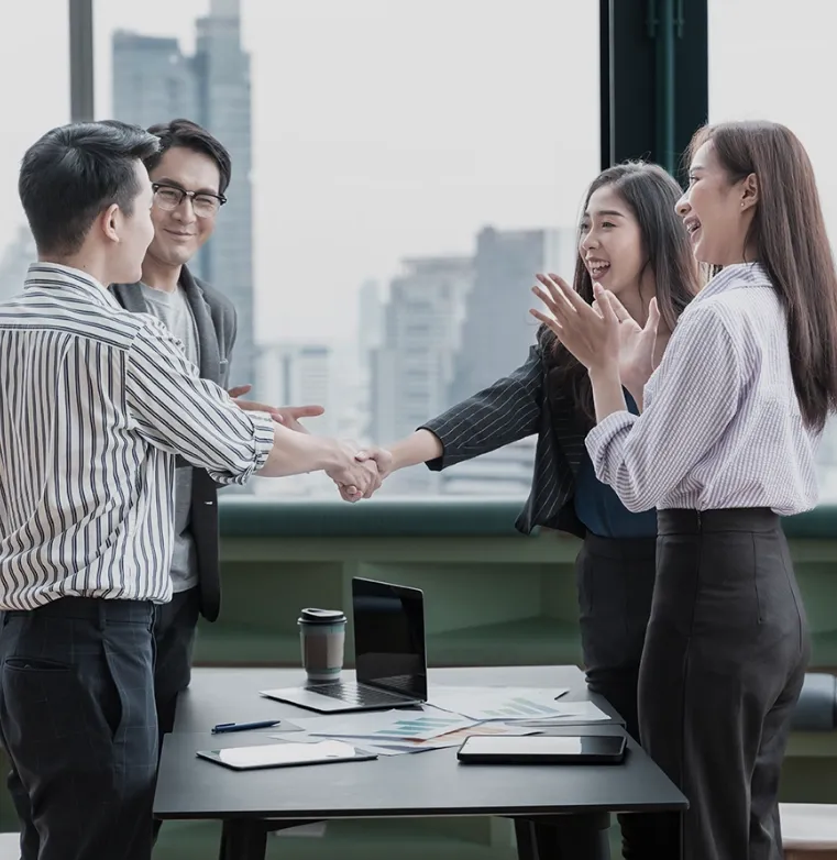 Handshake between business professionals, symbolizing Trinergy's focus on building long-term business relationships.